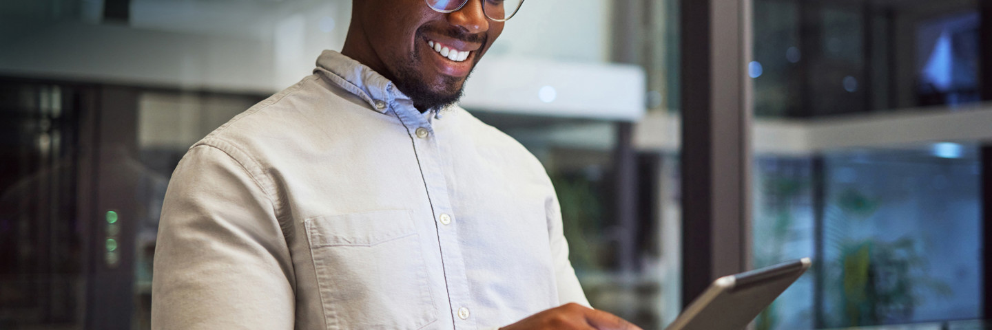 Image of man smiling at tablet