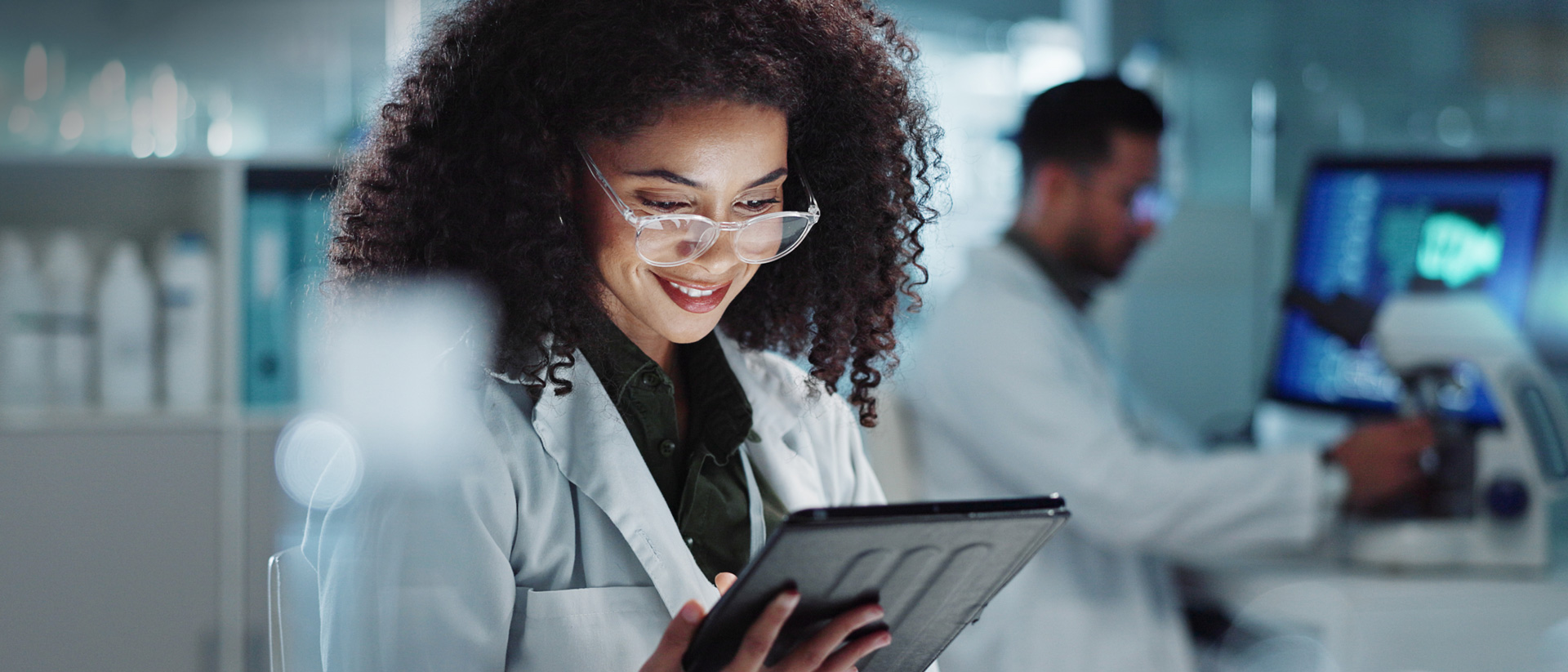 Vet looking at data on a tablet in a lab