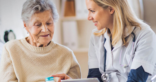 Nurse or carer talking to a older lady