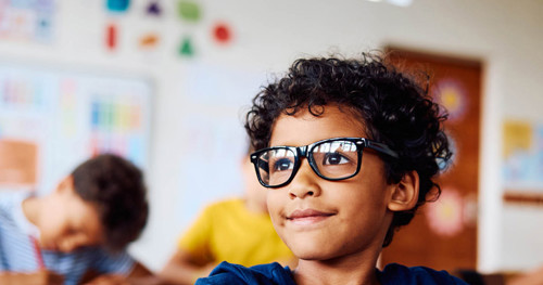 Child with glasses smiling