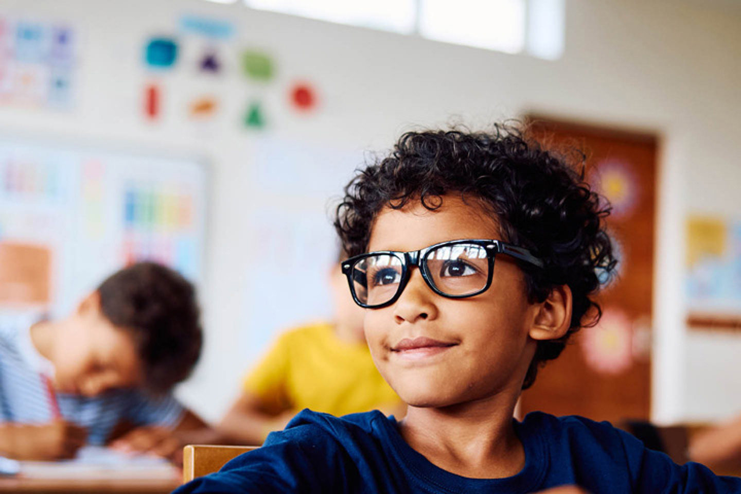 Child with glasses smiling