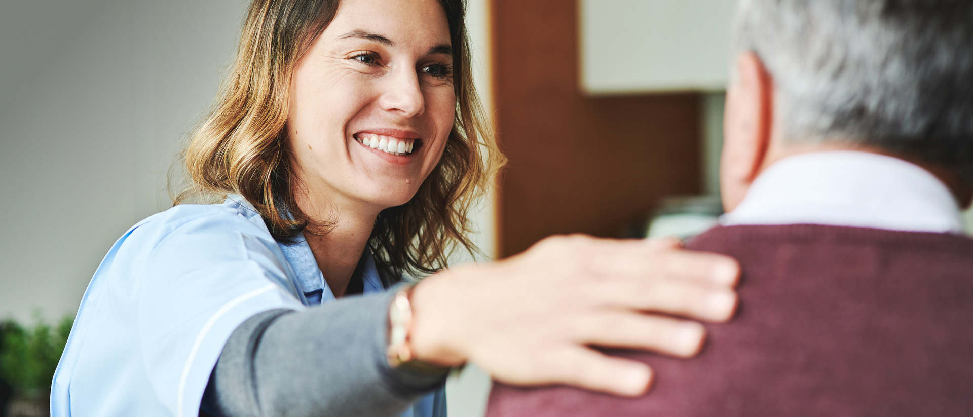 Nurse talking with elderly patient