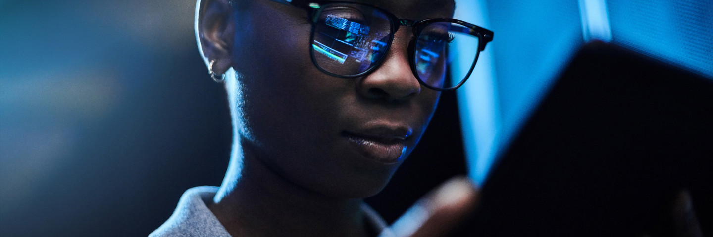 Image of woman with screen reflected in glasses