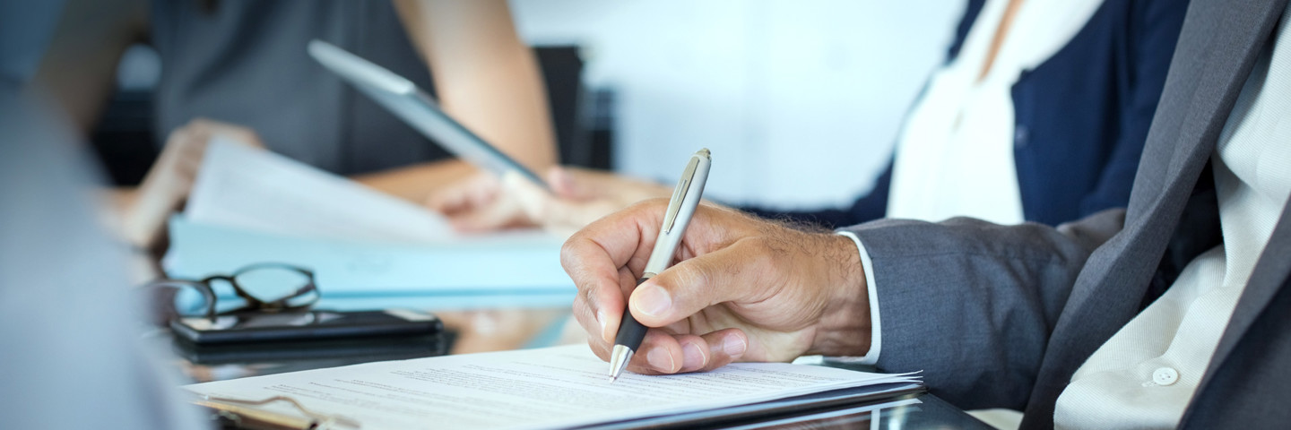 Image of man's hand writing on paper